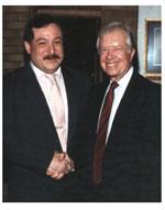 Avram C. Freedberg shakes hands with former President Jimmy Carter at Congregation Agudath Sholom.